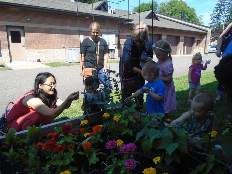 Children and adults learn about plants in the Minocqua Public Library garden