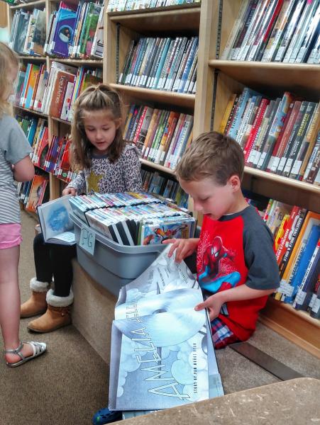 Kids finding books on the bookmobile