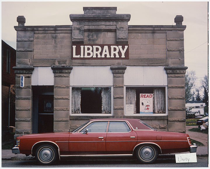 Image of branch library with red car parked in front