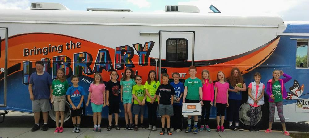 Kids standing in front of the bookmobile