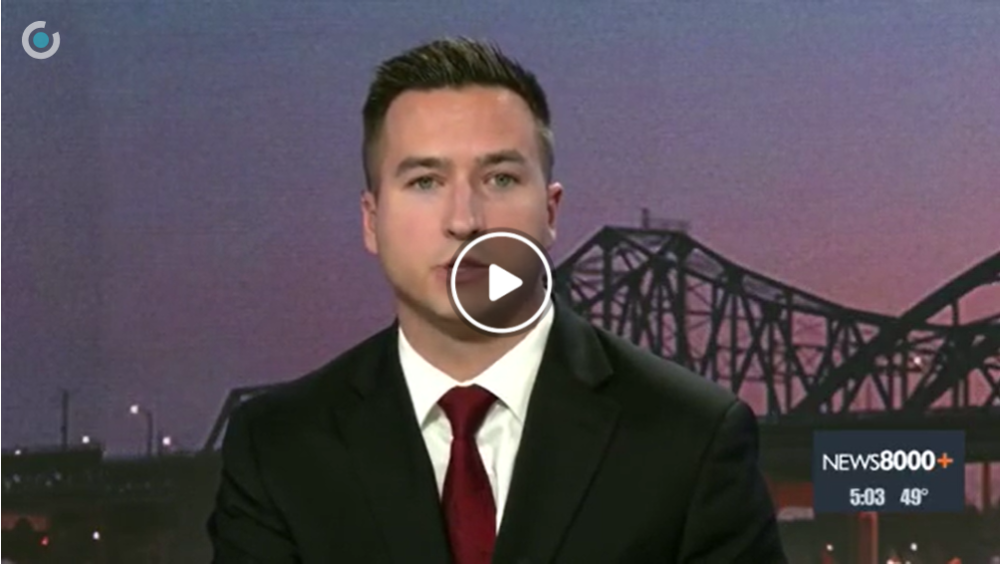 Image of paused video with male newscaster 